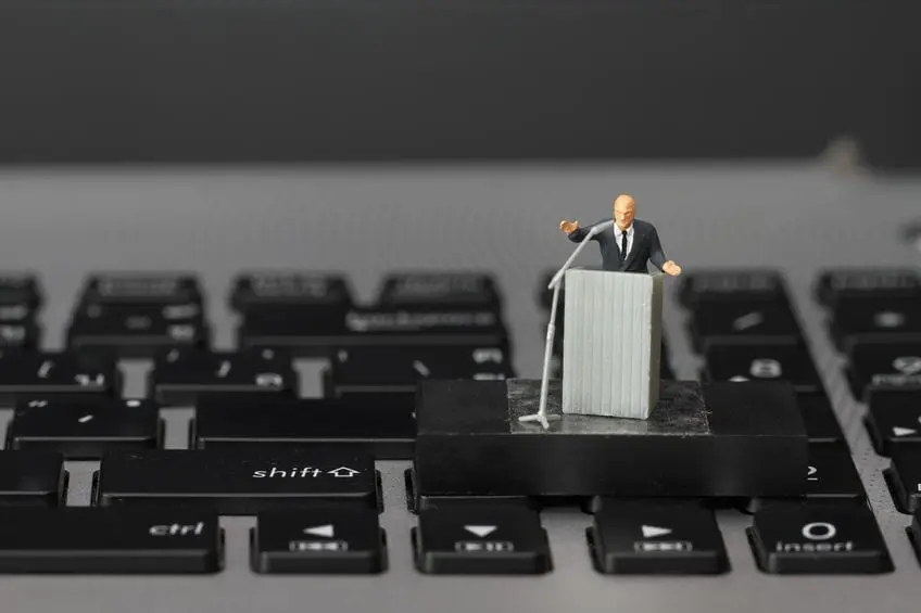 Photo of toy man at podium on keyboard