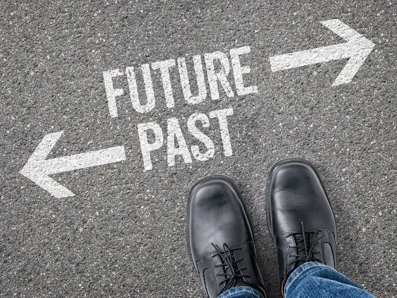 Black dress shoes on pavement with future-past text/arrows - future of consulting concept