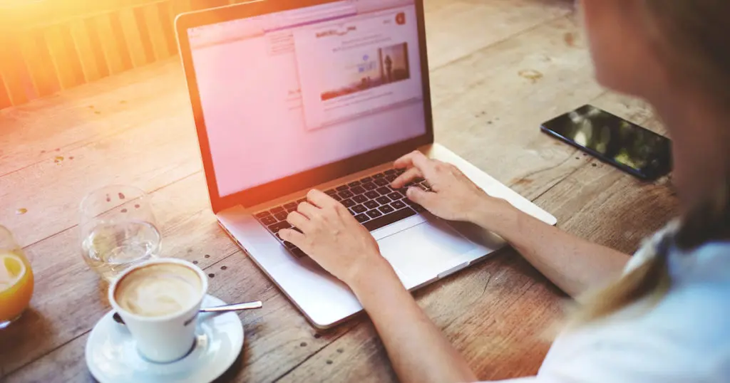 Cropped shot view of young smart female student learning on-line via laptop computer before her lectures.