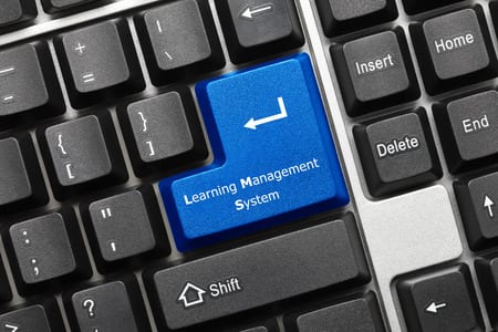 Photo of Learning Management System return key on keyboard for Small Business LMS concept