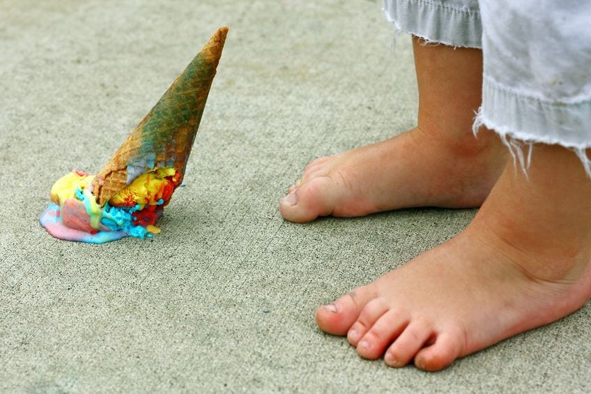 dropped ice cream cone at child's feet
