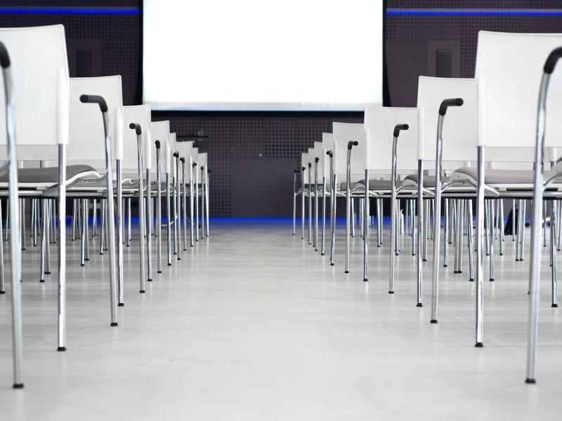 Photo of chairs/screen in meeting room for start seminar business concept