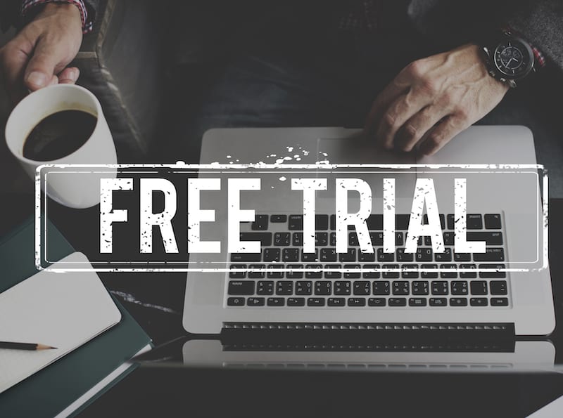 Hands on Laptop with "Free Trial" superimposed