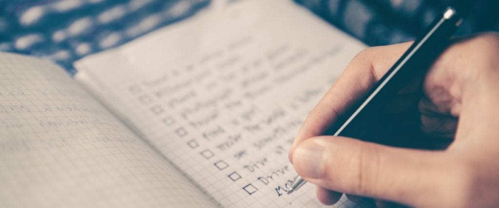 A list of reasons written in a notebook for starting a membership site