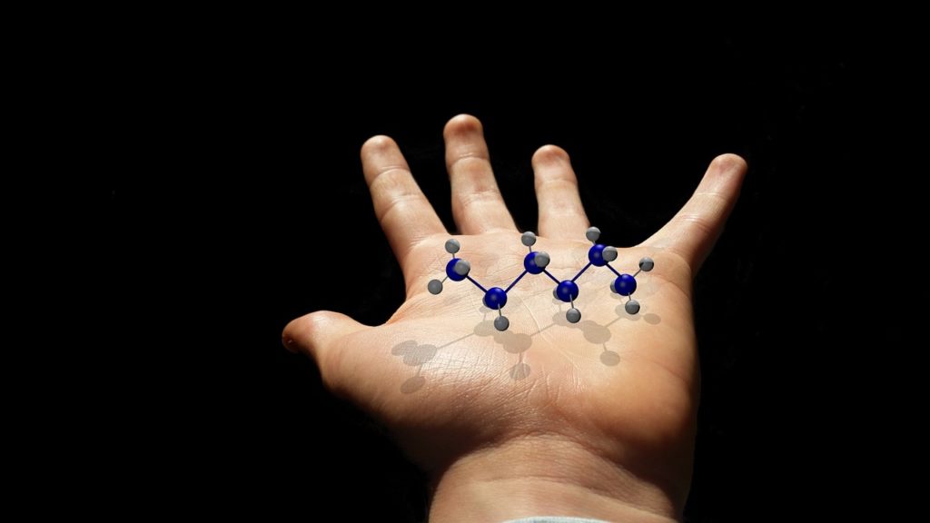 Image of a hand holding a molecule
