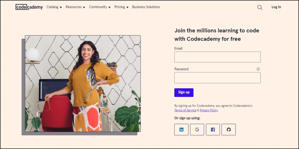 Codecademy home page - smiling woman on one side of page next to text, "Join the millions learning to code with Coacademy for free" and space to enter email and password to sign up