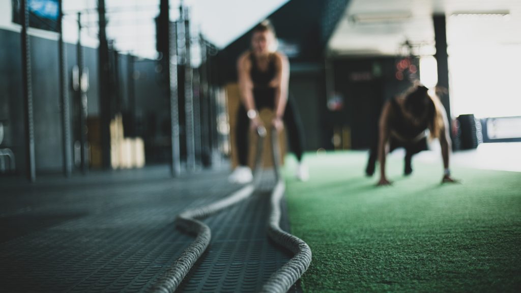 Bootcamp - person holding ropes, other person doing pushups