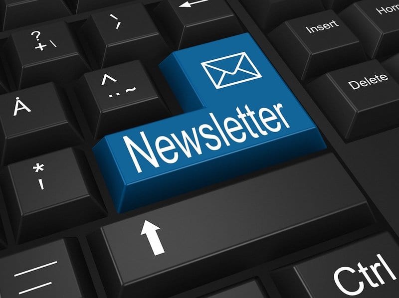 Blue newsletter key on black keyboard for monetize your email newsletter concept