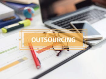 Image of laptop, phone, business documents with "Outsourcing" superimposed