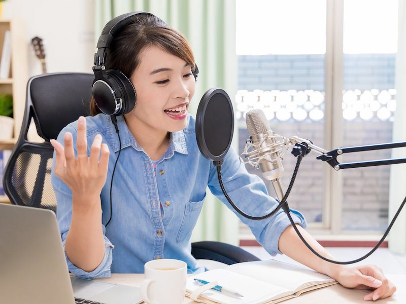 Asian woman recording podcast for start a podcast concept