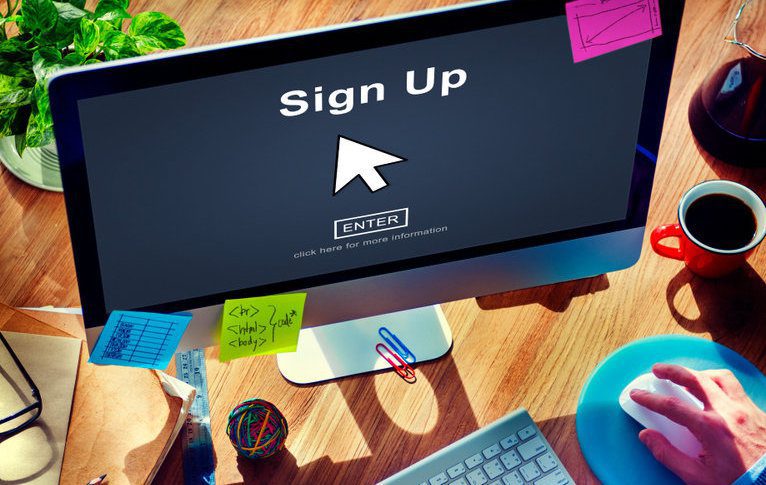 "Sign Up" with arrow on desktop computer screen with sticky notes for  Webinar promotion concept