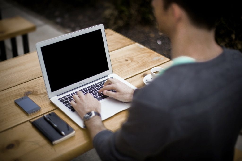 Man typing at laptop - write an ebook concept